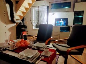 a living room with two chairs and a table with food at Agroturystyka u Cezarego in Liniewo