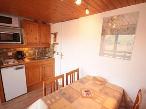 a kitchen with a table and a kitchen with a sink at Studio Les Saisies, 1 pièce, 4 personnes - FR-1-293-146 in Les Saisies