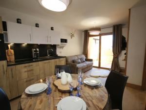 a living room with a table and a kitchen at Appartement Hauteluce, 3 pièces, 6 personnes - FR-1-293-268 in Hauteluce