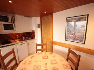 a kitchen with a table and chairs and a kitchen with a sink at Appartement Les Saisies, 2 pièces, 5 personnes - FR-1-293-124 in Les Saisies