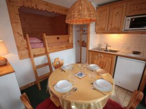 a kitchen with a table and a bunk bed at Appartement Les Saisies, 2 pièces, 4 personnes - FR-1-293-159 in Les Saisies