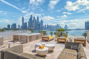 a rooftop patio with a view of the city at FIVE Palm Beach Villa - Three Floors, Private Pool, Jacuzzi in Dubai