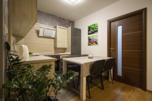 a kitchen with a table and chairs in a room at Apartman Adam in Veľký Slavkov
