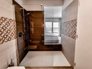 a bathroom with a shower with a glass door at Pitla Cuna Eco Relais in Terlano