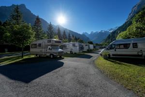 a group of rvs parked on a gravel road at Alpenresort Eienwäldli Camping in Engelberg