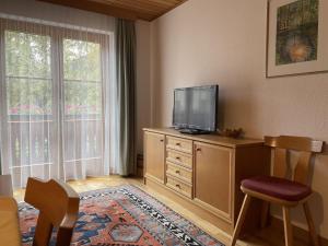 a living room with a flat screen tv on a dresser at Apartment Ilishof in Schruns-Tschagguns