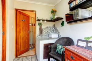 a kitchen with a counter and a wooden door at Penguin - Double En-Suite Studio in Cape Town