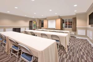 a conference room with tables and chairs and a podium at Microtel Inn & Suites by Wyndham Gardendale - Birmingham North in Gardendale
