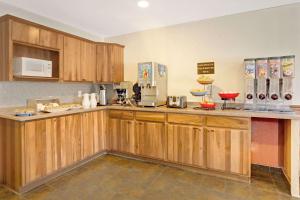 a kitchen with wooden cabinets and a counter top at Ramada by Wyndham Draper in Draper