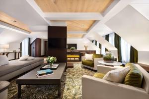 a living room with couches and a table at Hyatt Paris Madeleine in Paris