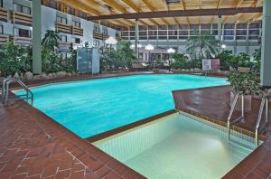 a large swimming pool in a large building at Baymont by Wyndham Red Deer in Red Deer