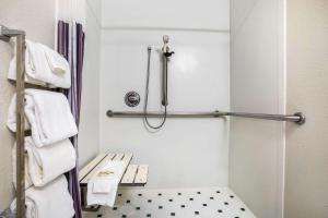 a small bathroom with a shower and towels at La Quinta by Wyndham Austin Southwest in Austin
