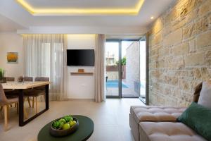 a living room with a couch and a table at Southern Paradise Villas in Kalamaki