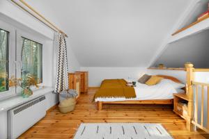 a bedroom with a bed and a window at Masuria Warsaw Family in Topolina