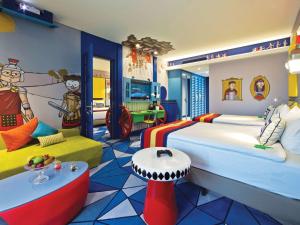 a childrens bedroom with a large bed and a couch at The Land Of Legends Kingdom Hotel - All-in Concept in Belek