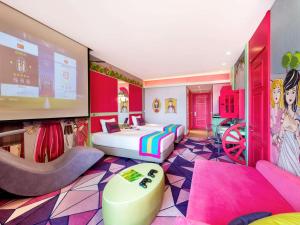 a room with a bedroom with a bed and a tv at The Land Of Legends Kingdom Hotel - All-in Concept in Belek