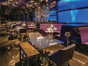 a dining room with tables and purple chairs at The Land Of Legends Kingdom Hotel - All-in Concept in Belek