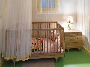 a crib in a room with a dresser and a lamp at The Land Of Legends Kingdom Hotel - All-in Concept in Belek