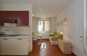 a kitchen and living room with a couch and a table at Residence San Rossore in Pisa
