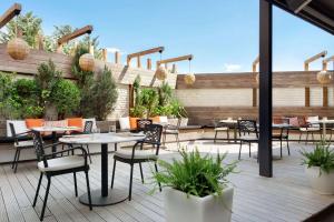 a patio with tables and chairs on a deck at Ramada Plaza by Wyndham Eskisehir in Eskisehir