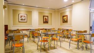 a restaurant with tables and chairs in a room at Crystal Hotel in Salta