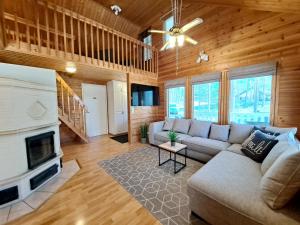 a living room with a couch and a fireplace at Jukuvilla in Kalajoki