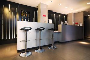 a bar with three stools at a counter in a store at Arc de Triomphe Etoile in Paris