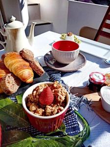 a table with a bowl of cereal and a bowl of strawberries at AQUADOURO Yacht RADAMES - Sleep Boat Experience in Castelo de Paiva