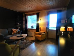 a living room with a couch and a table and a window at Flåm Marina in Flåm