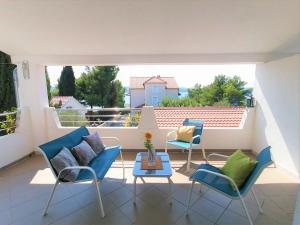a patio with two chairs and a table on a balcony at Apartments M in Pirovac