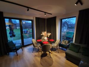 a living room with a table and chairs at AleChatki Roztocze Siedliska in Siedliska