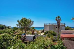 a view of the ocean from a house at Villa Margherita by BarbarHouse in Punta Prosciutto