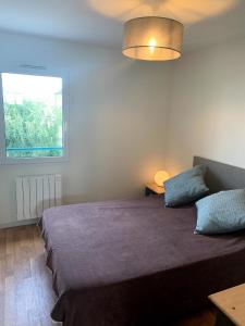 Un dormitorio con una cama grande y una ventana en 65 m2 Centre vannes 2 ch wifi parking, en Vannes