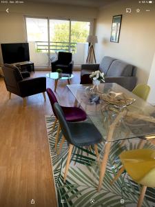 a living room with a glass table and chairs at 65 m2 Centre vannes 2 ch wifi parking in Vannes