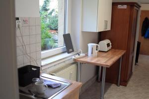 a small kitchen with a counter and a window at Apartment Spring Creek in Merseburg