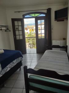 Voodi või voodid majutusasutuse Pousada Caravelas - Centro de Paraty toas