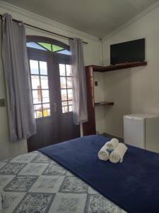 Voodi või voodid majutusasutuse Pousada Caravelas - Centro de Paraty toas