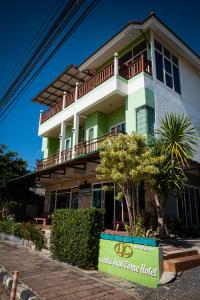 a house with a sign in front of it at Lanta Just Come Hotel in Ko Lanta