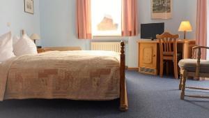 Postel nebo postele na pokoji v ubytování Hotel garni Floriani + 6 fotografií