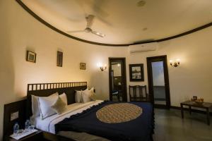 a bedroom with a large bed with a ceiling at Heritage Khirasara Palace in Rajkot