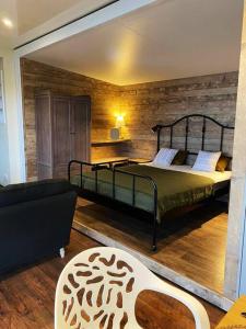 1 dormitorio con 1 cama grande y 1 sofá en Odhrán Lodge, St Conan's Escape: Home with a view, en Loch Awe