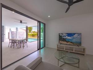 a living room with a glass table and chairs at Villa Selena in Lamai