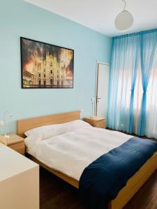 Un pat sau paturi într-o cameră la Via Padova 165