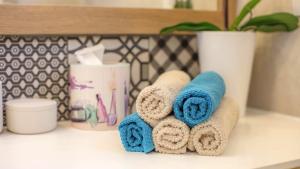 a pile of towels sitting on a bathroom counter at Cozy apartment in the heart of Mali Lošinj - 45 m² with view in Mali Lošinj +34 photos