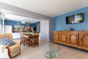 a living room with a couch and a dining room at Les Bords de Saône in Rigny