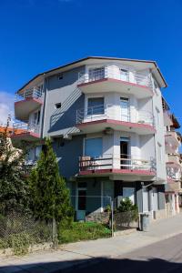 a tall building with balconies on the side of it at Villa Maris in Obzor
