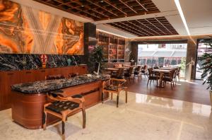 a restaurant with tables and chairs and a large painting on the wall at Henna Hotel Istanbul in Istanbul