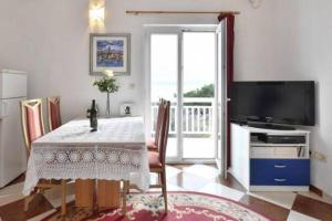 sala de estar con mesa y TV en Apartment in Duce with sea view, balcony, air conditioning, WiFi 5063-2, en Duće
