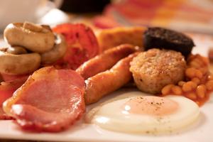 a plate of food with eggs and meat and beans at Hawthorn Lodge in Belturbet