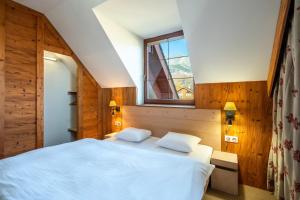 Ein Bett oder Betten in einem Zimmer der Unterkunft Kukučka Lomnica - Tatranská Lomnica